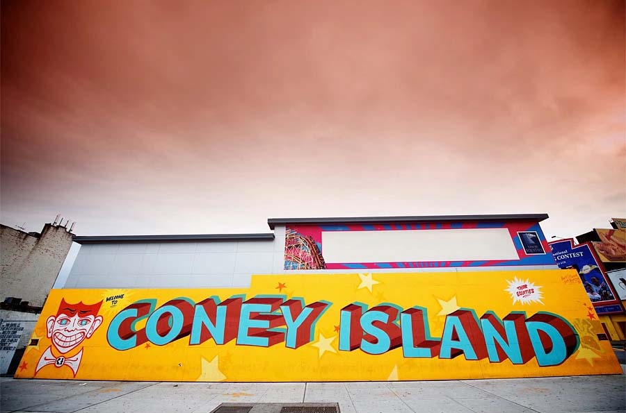 A bright mural reads 